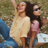 The difference between a casual friend and a true friend, shown through two women enjoying a playful moment together outdoors