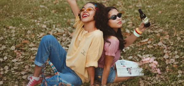 The difference between a casual friend and a true friend, shown through two women enjoying a playful moment together outdoors