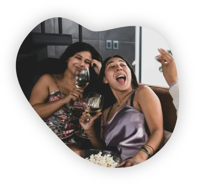 Two women making friends and enjoying a relaxed evening together at home