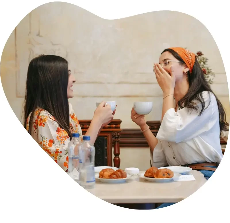 Two women meeting for coffee and getting to know each other, showing how friendships start
