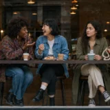accidentally excluding a friend: women sharing a quiet moment at a café